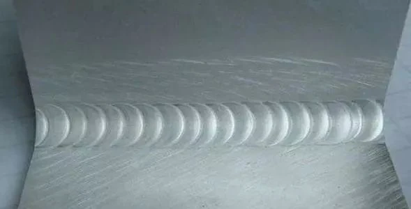 Smooth and visually pristine laser weld joint on a 6000 series aluminum plate, illustrating minimal Heat-Affected Zone (HAZ)